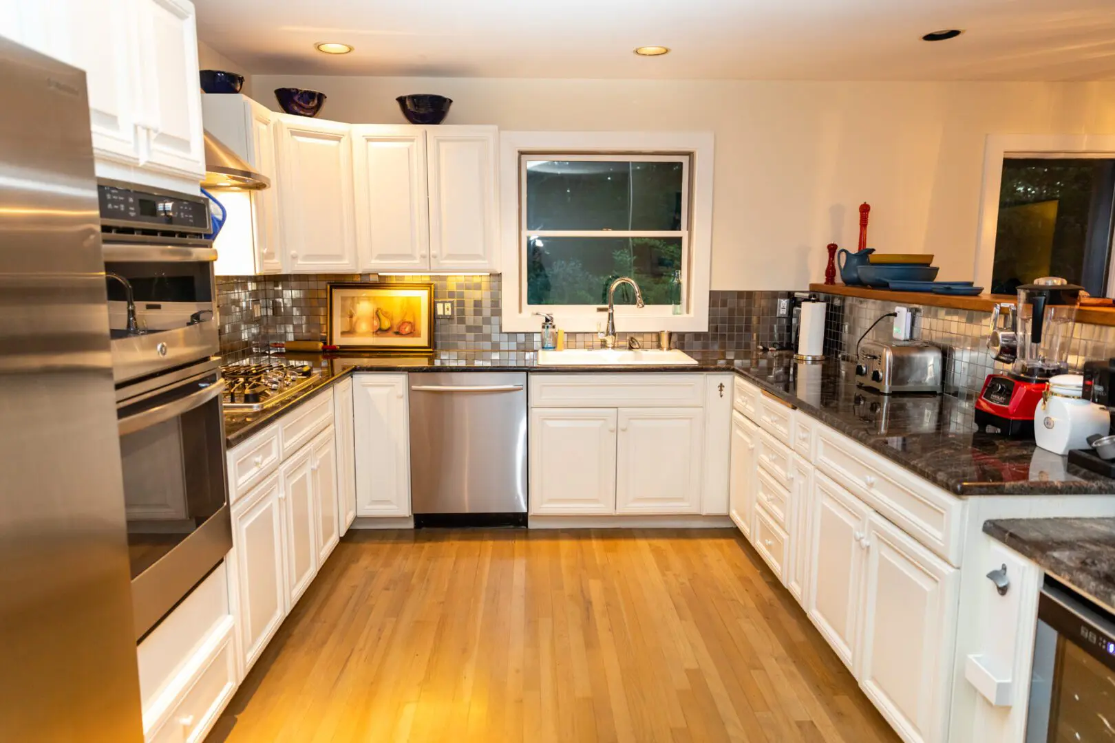 White kitchen with stainless steel appliances.